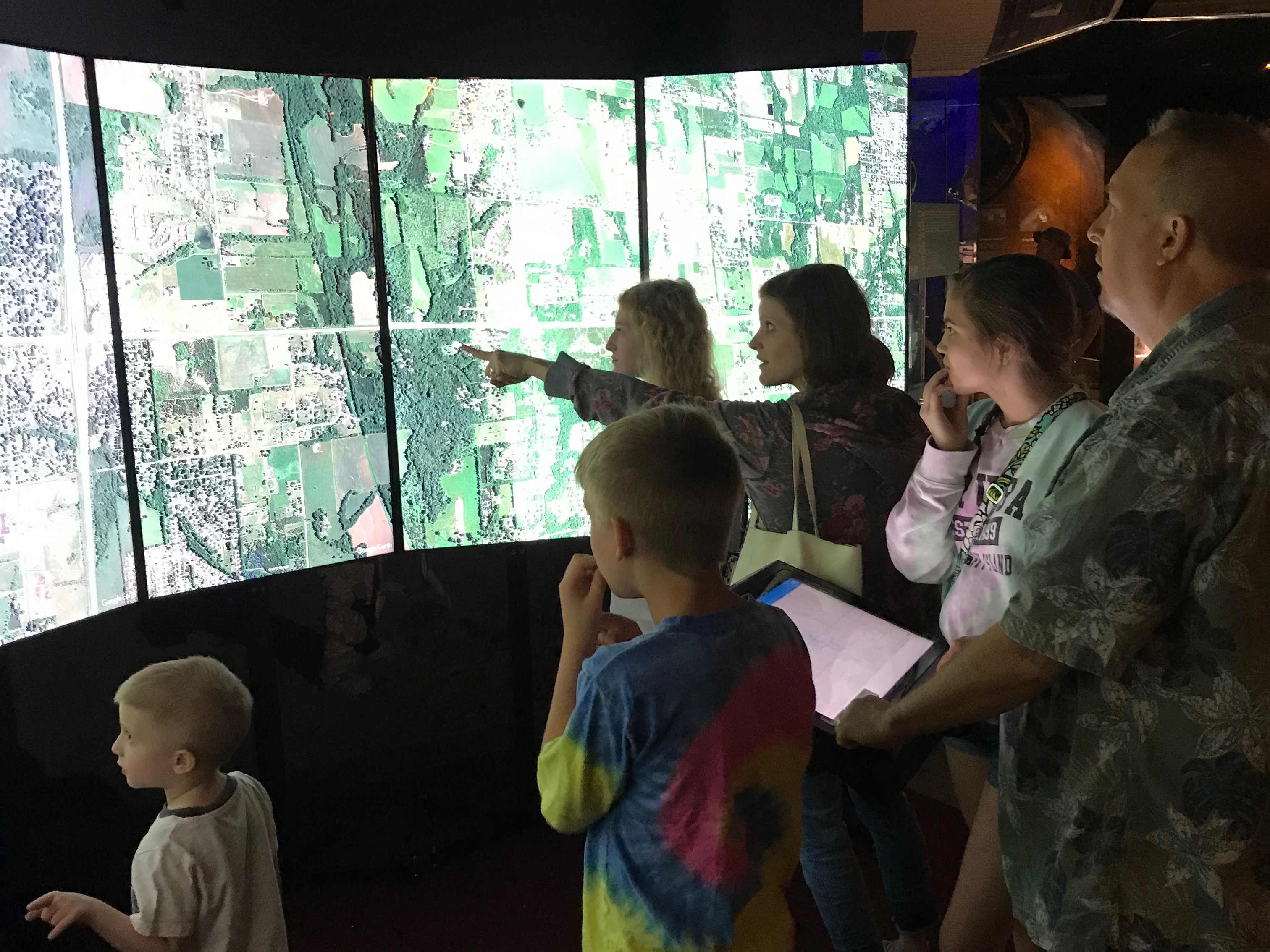 A family exploring the Liquid Galaxy