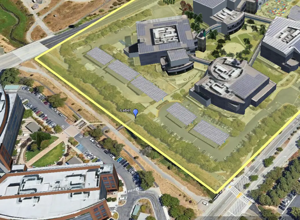 Google earth showing a campus of several buildings, surrounded by a yellow rectangle overlay, and with a blue pin labeled “label” on one side.