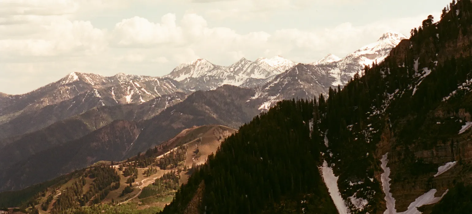 Layers of mountains are exposed by light with a red tint